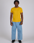Jr. Varsity Tee in Sunshine Yellow and light wash Denim Drop Pocket Pants on Isaac