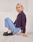 Madeline is wearing Ricky Jacket in Nebula Purple and light wash Carpenter Jeans