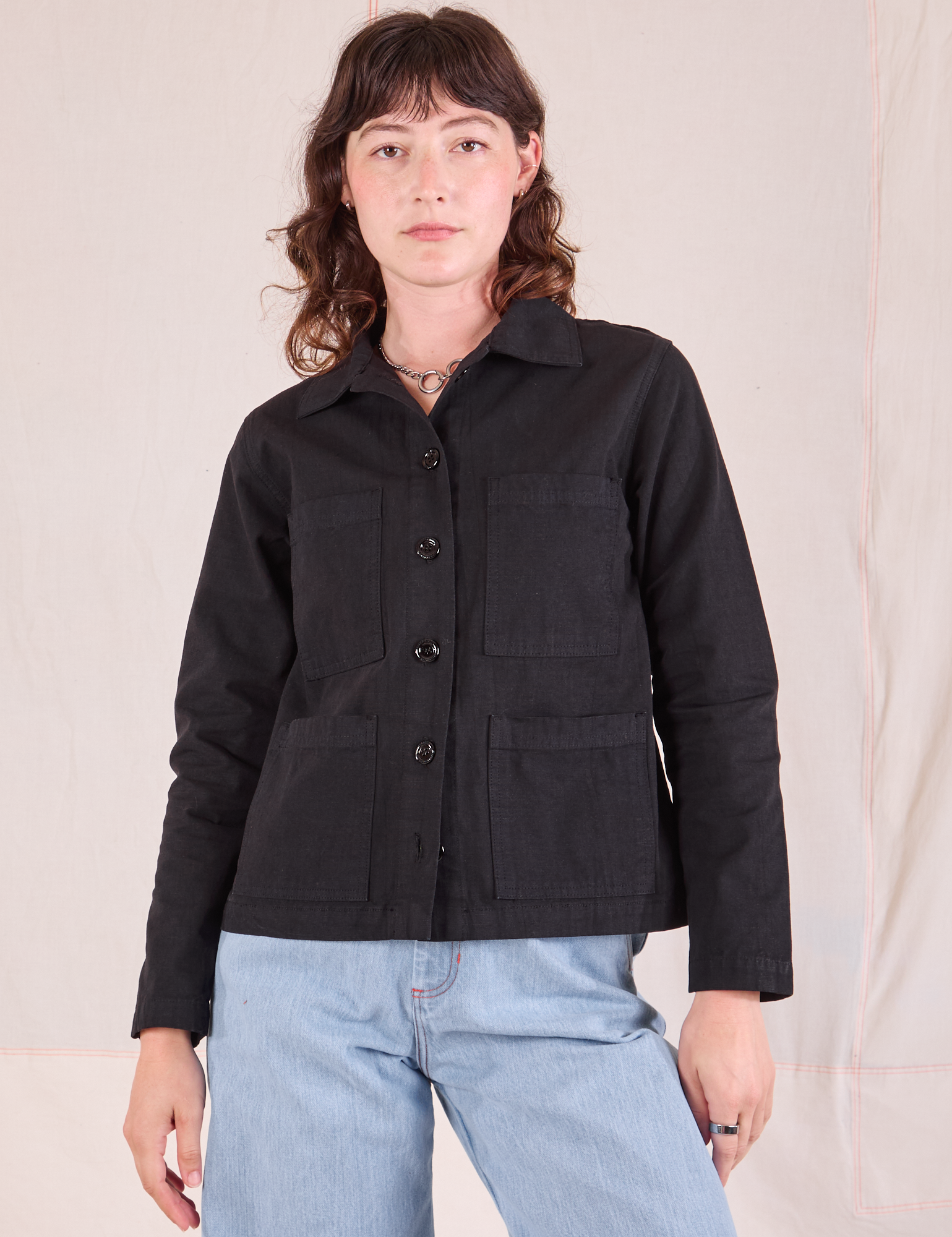 Alex is wearing a buttoned up Ripstop Work Jacket in Basic Black