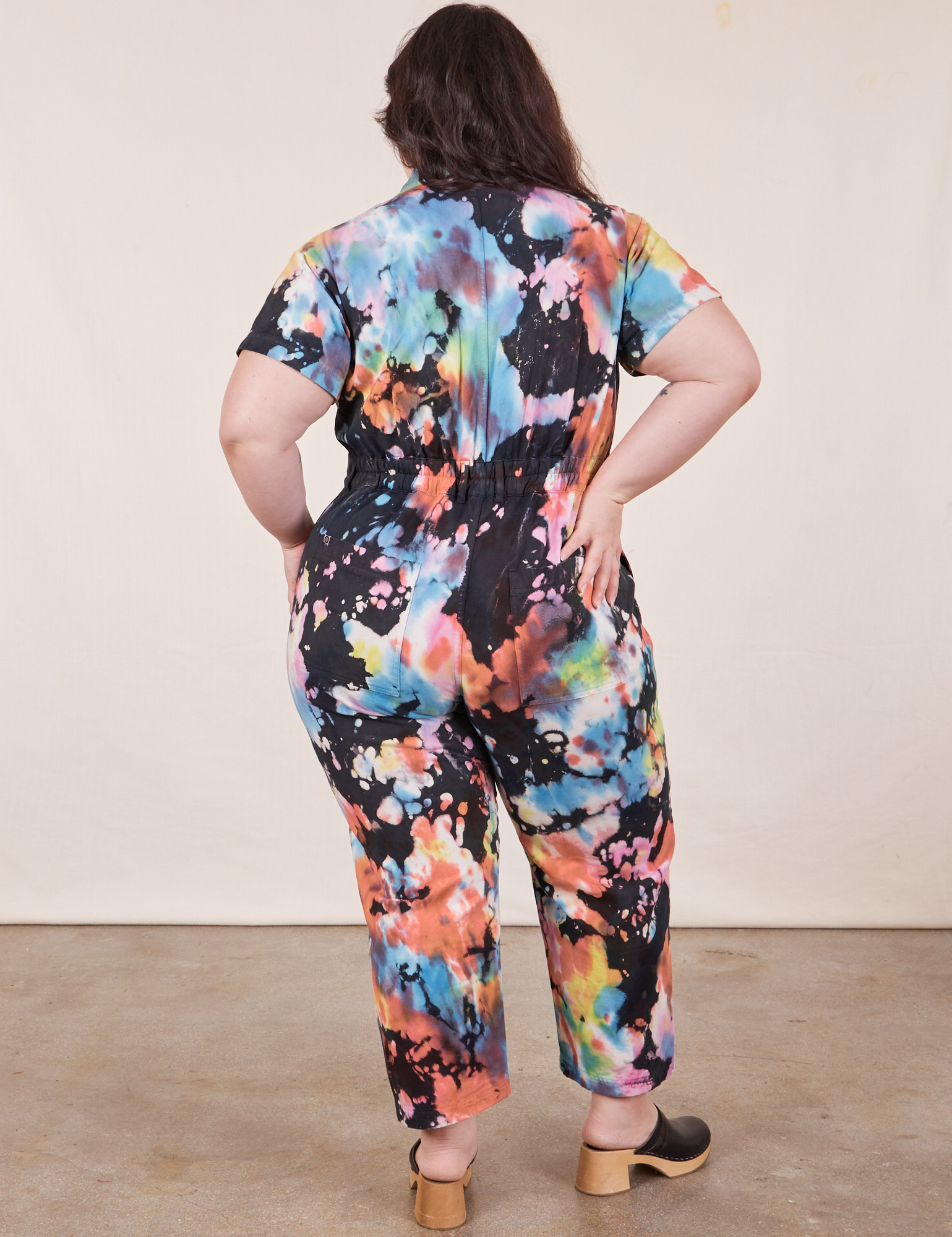 Back view of Petite Short Sleeve Jumpsuit in Rainbow Magic Waters worn by Ashley