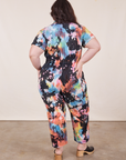 Back view of Petite Short Sleeve Jumpsuit in Rainbow Magic Waters worn by Ashley
