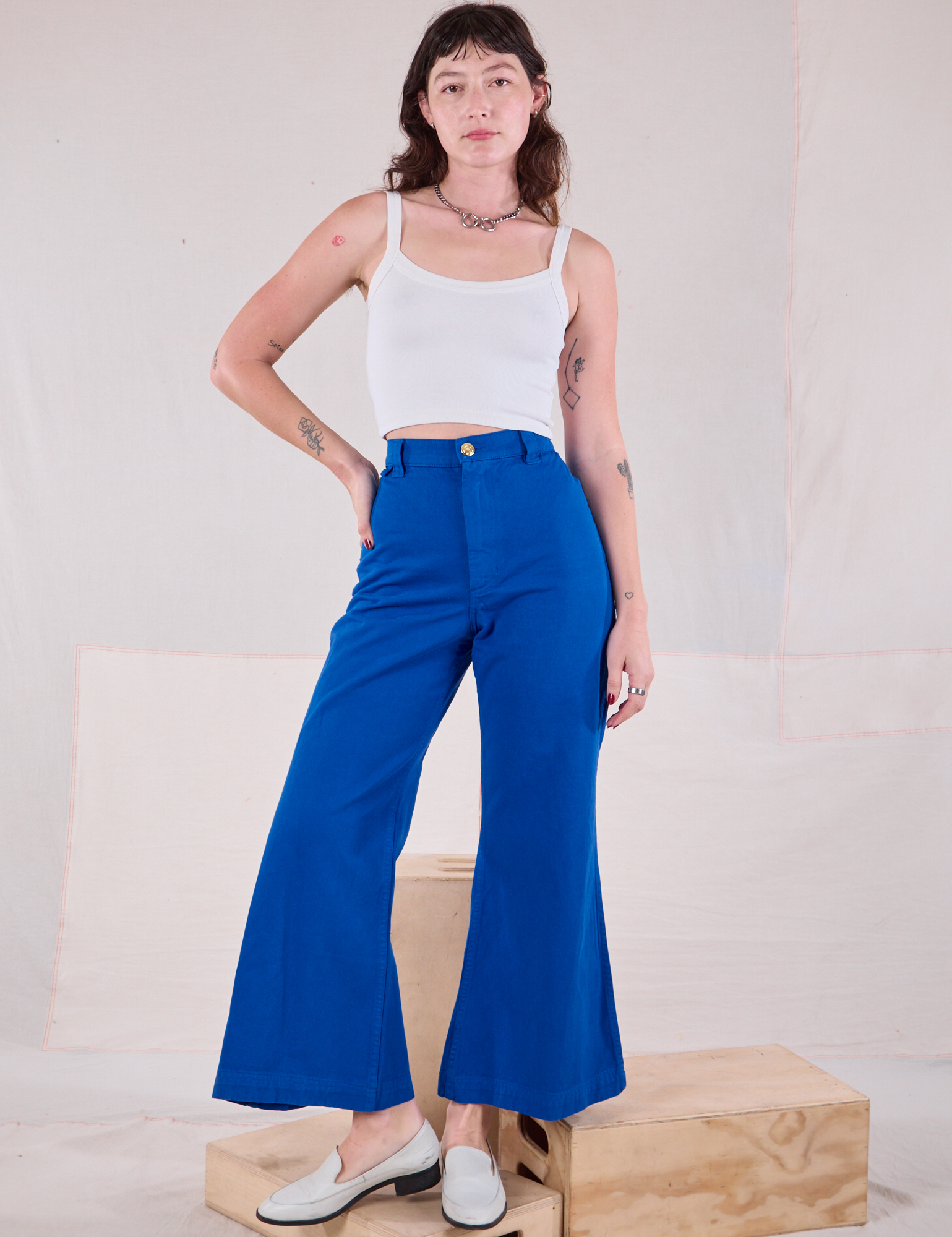 Alex is 5&#39;8&quot; and wearing XXS Bell Bottoms in Royal Blue paired with Cami in Vintage Tee Off-White