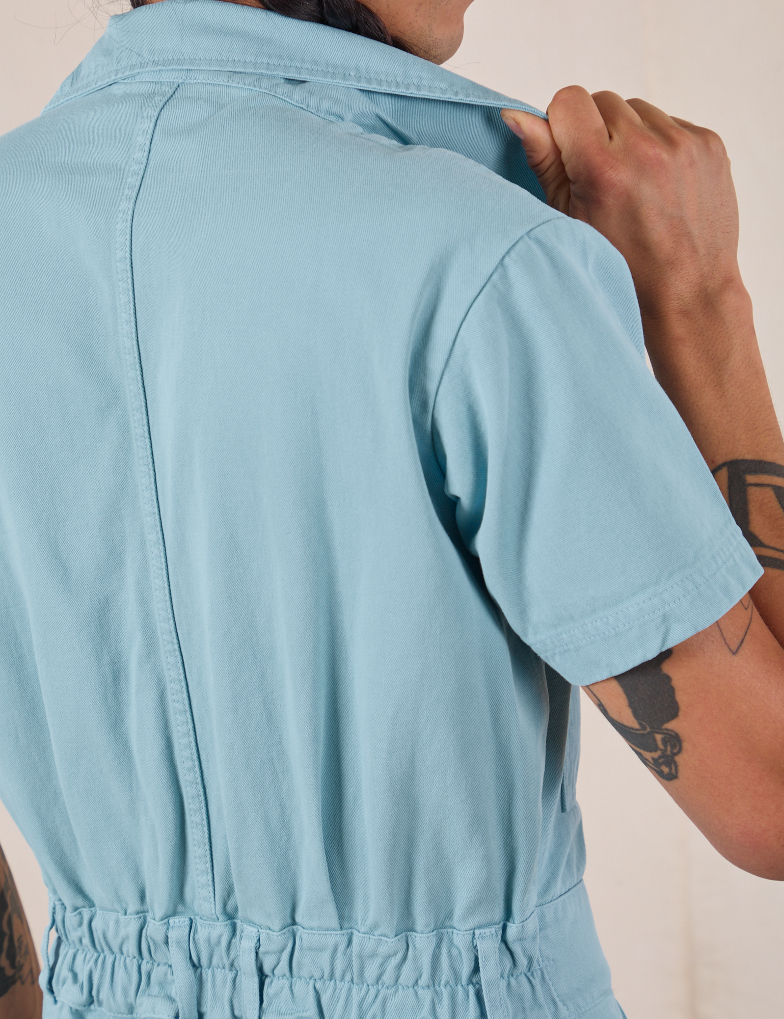 Short Sleeve Jumpsuit in Baby Blue back shoulder close up on Anthony