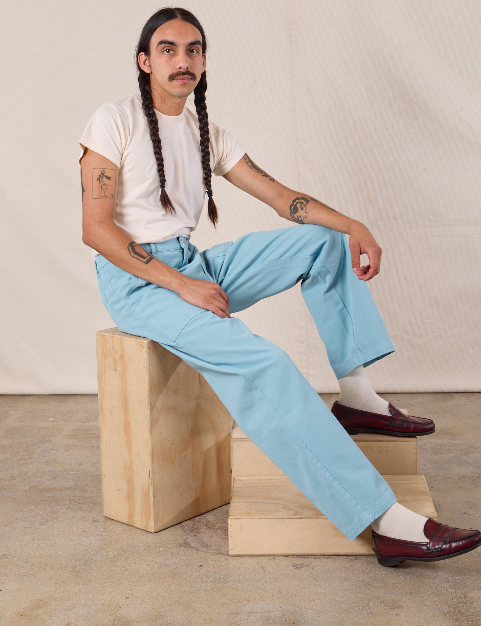 Anthony is wearing Work Pants in Baby Blue and Organic Vintage Tee in Vintage Tee Off-White