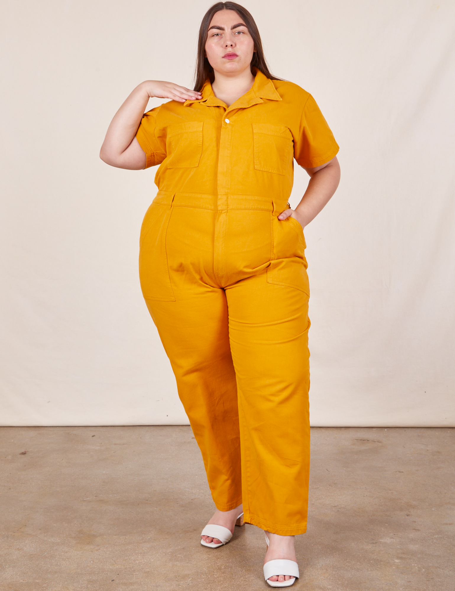 Marielena is 5’8” and wearing 2XL Short Sleeve Jumpsuit in Mustard Yellow