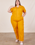 Marielena is 5’8” and wearing 2XL Short Sleeve Jumpsuit in Mustard Yellow