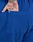 Close up of Sam's hand in the back pocket of Short Sleeve Jumpsuit in Royal Blue