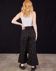 Back view of Star Bell Bottoms in Black and Cropped Tank in vintage tee off-white on Margaret