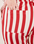 Cherry Stripe Jumpsuit back pocket close up. Sydney has her hand in the pocket.