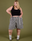 Juliet is 5’7” and wearing 2XL Longline Work Shorts in Natural paired with a black Cropped Tank