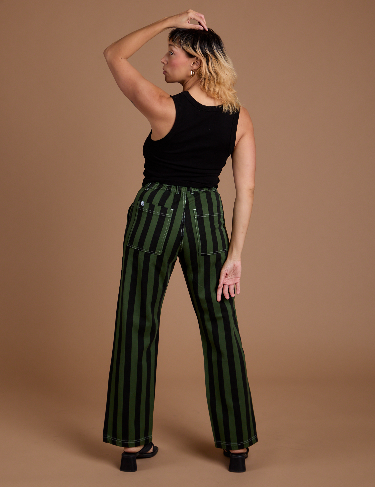 Back view of Black Stripe Work Pants in Evergreen and black Cropped Tank on Tiara