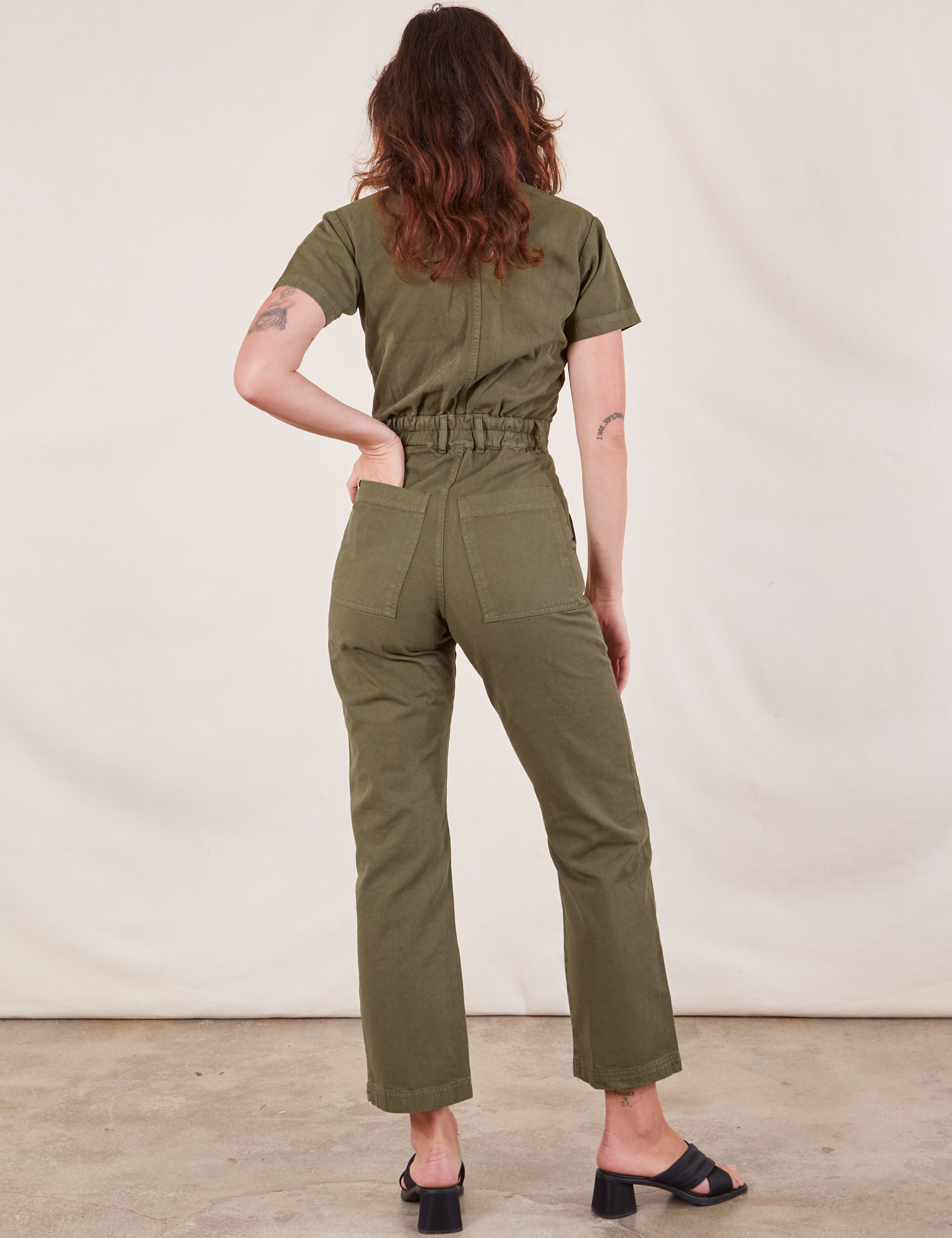 Short Sleeve Jumpsuit in Surplus Green back view on Alex