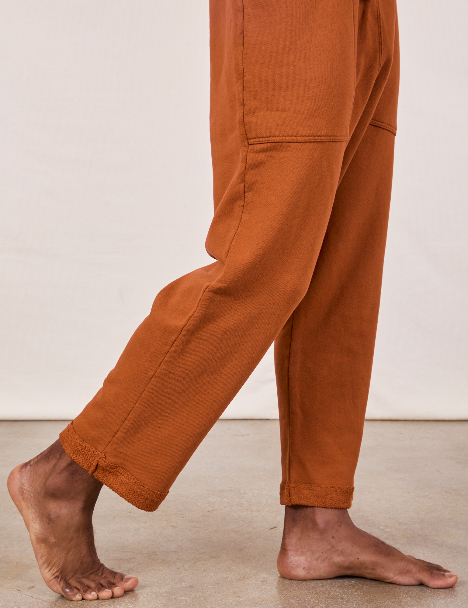 Cropped Rolled Cuff Sweatpants in Burnt Terracotta pant leg side view close up on Jerrod