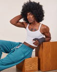 Jerrod is wearing Cropped Rolled Cuff Sweatpants in Marine Blue and vintage off-white Cami