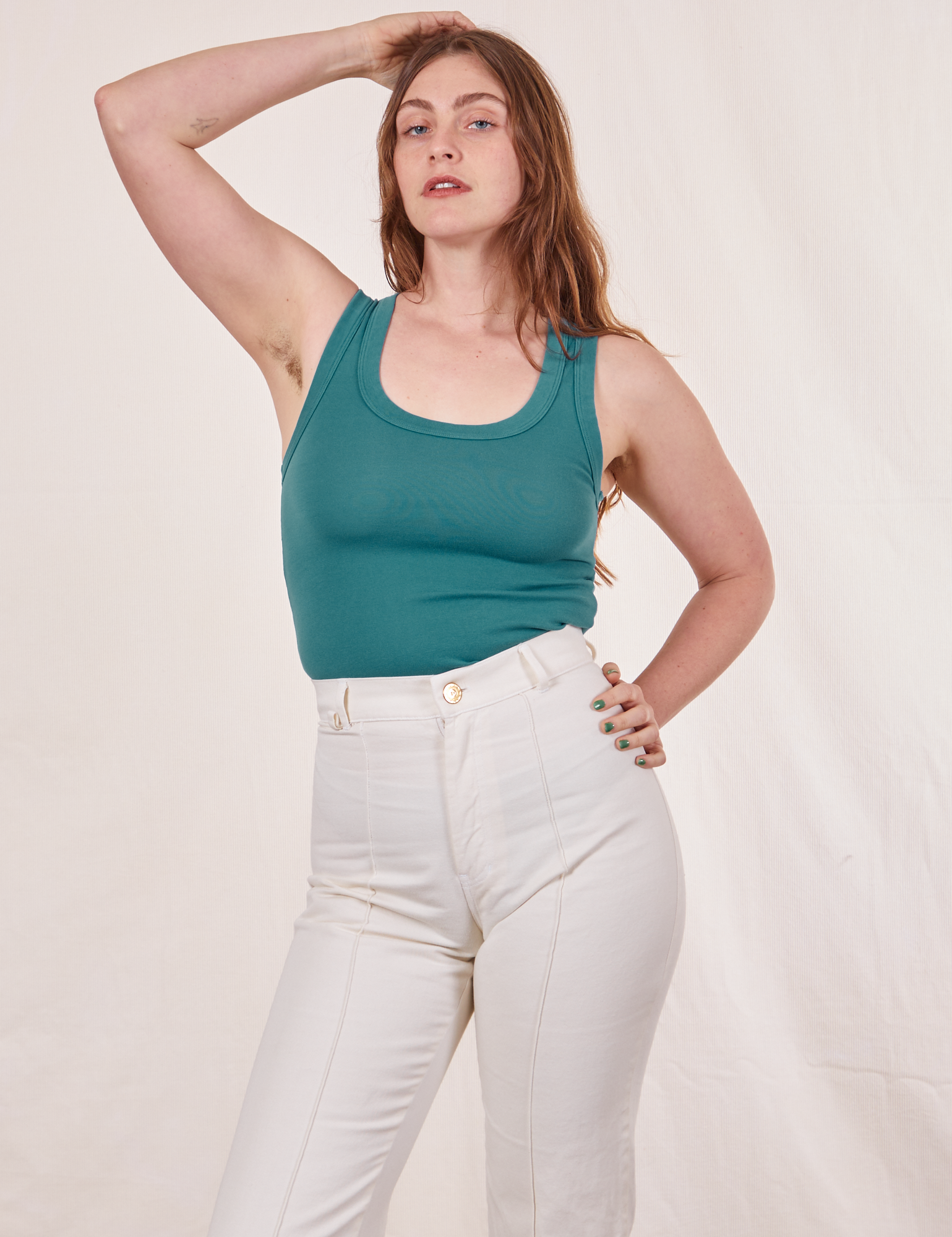 Allison is wearing size XXS Tank Top in Marine Blue paired with vintage off-white Western Pants