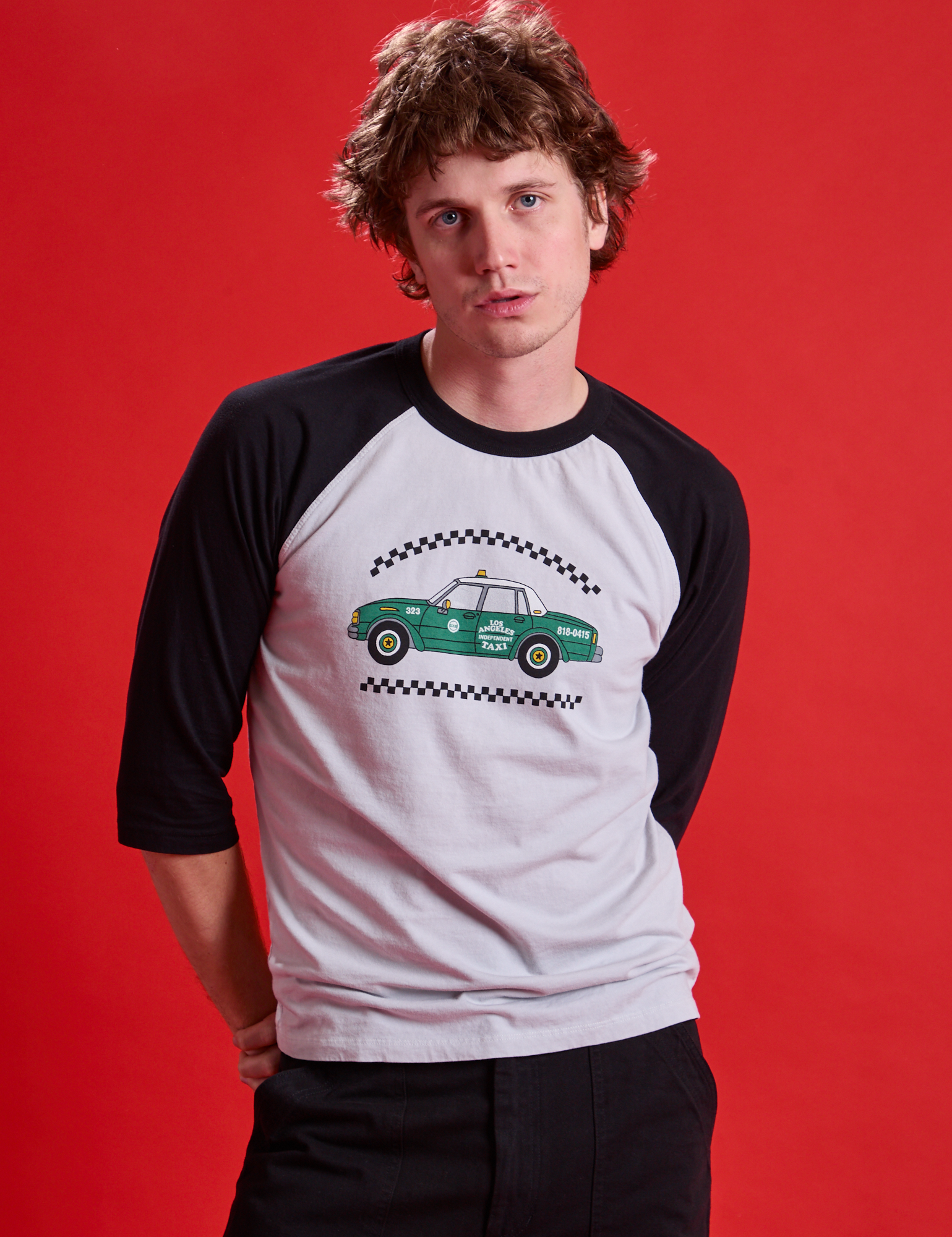 Quinn is wearing Taxi Raglan Tee in Los Angeles