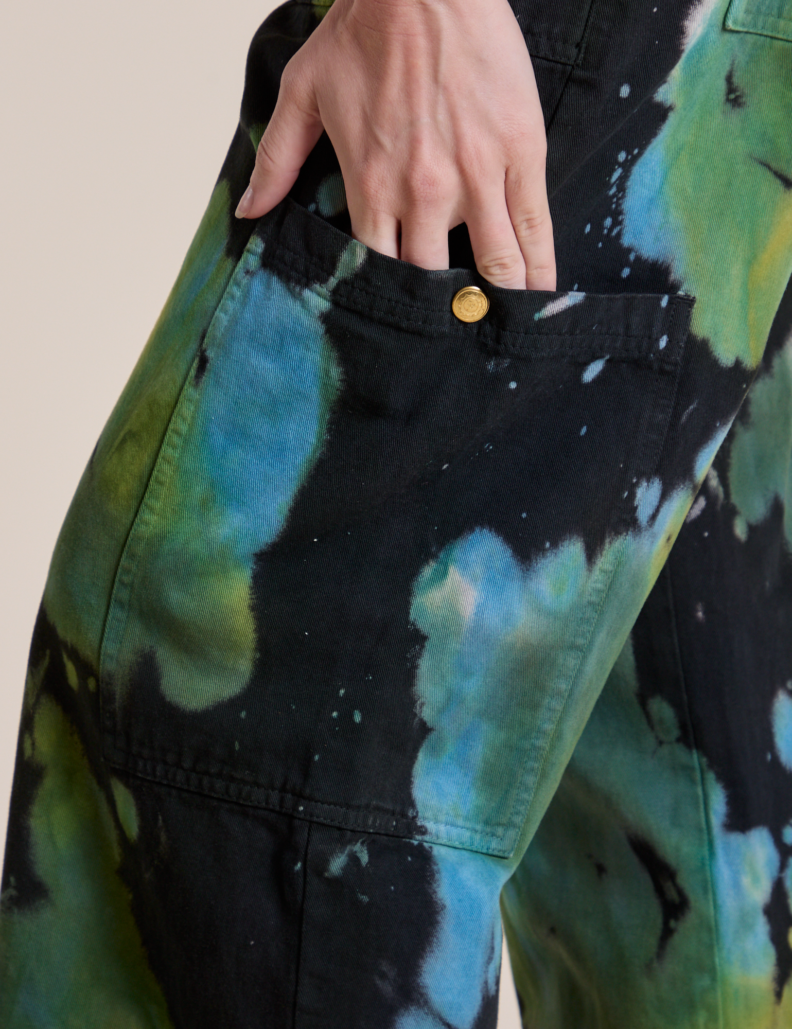 Close up of Alex's hand in the Magic Waters Drop Pocket Pants in Green Pool pant leg pocket 