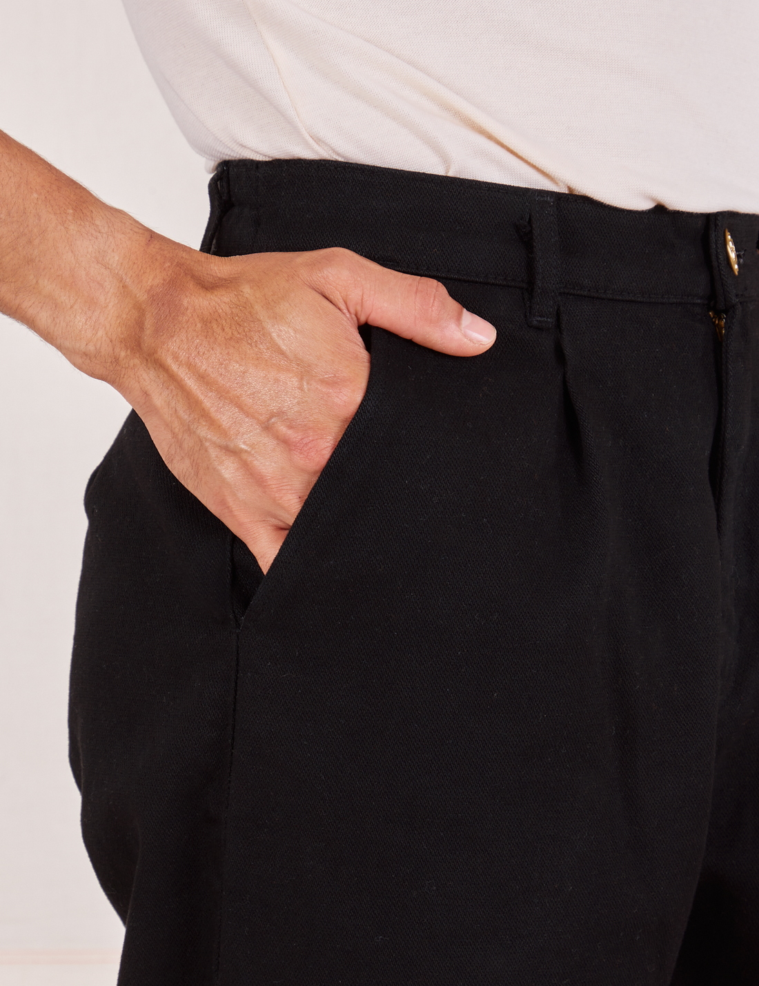 Front pocket close up of Denim Trouser Jeans in Black. Jesse has their hand in the pocket.
