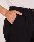 Front pocket close up of Denim Trouser Jeans in Black. Jesse has their hand in the pocket.