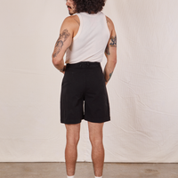 Back view of Trouser Shorts in Basic Black and vintage off-white Tank Top worn by Jesse