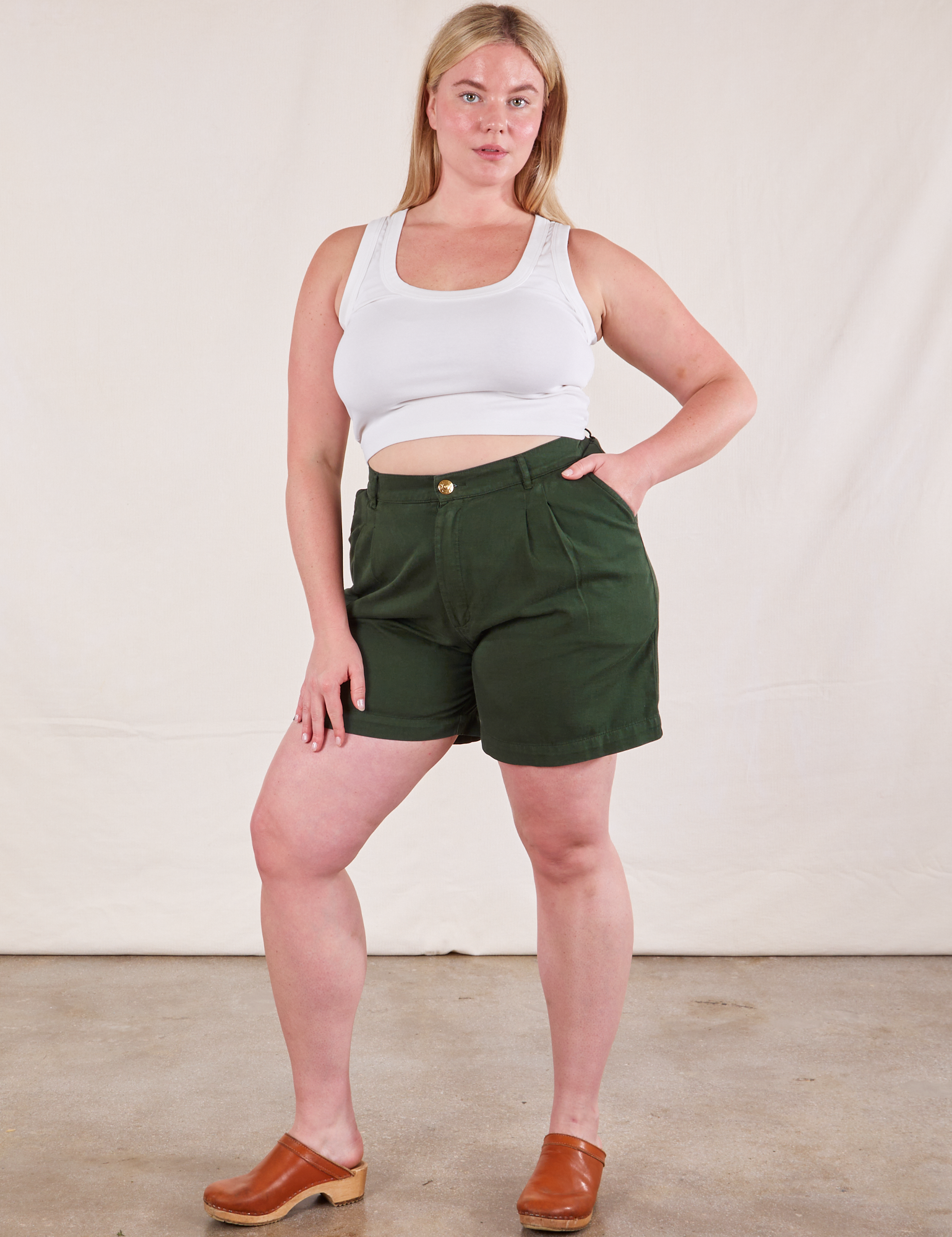 Lish is 5&#39;8&quot; and wearing M Trouser Shorts in Swamp Green paired with Cropped Tank Top in Vintage Tee Off-White
