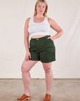 Lish is 5'8" and wearing M Trouser Shorts in Swamp Green paired with Cropped Tank Top in Vintage Tee Off-White