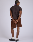 Back view of Pleated Trouser Shorts in Fudgesicle Brown and espresso brown Organic Vintage Tee