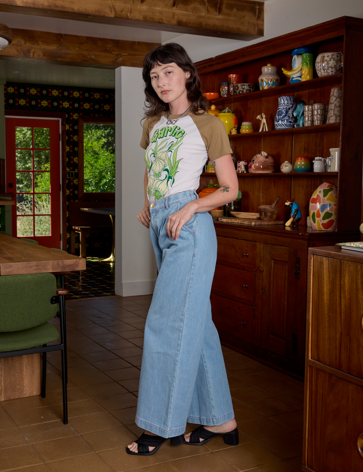 Side view of Short Sleeve Raglan Tee in Garlic and light wash Indigo Denim Trousers on Alex