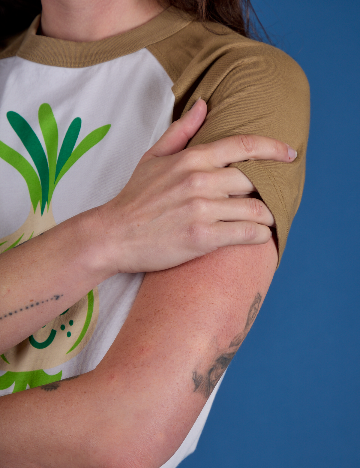 Produce Raglan Tee in Onion sleeve close up on Alex