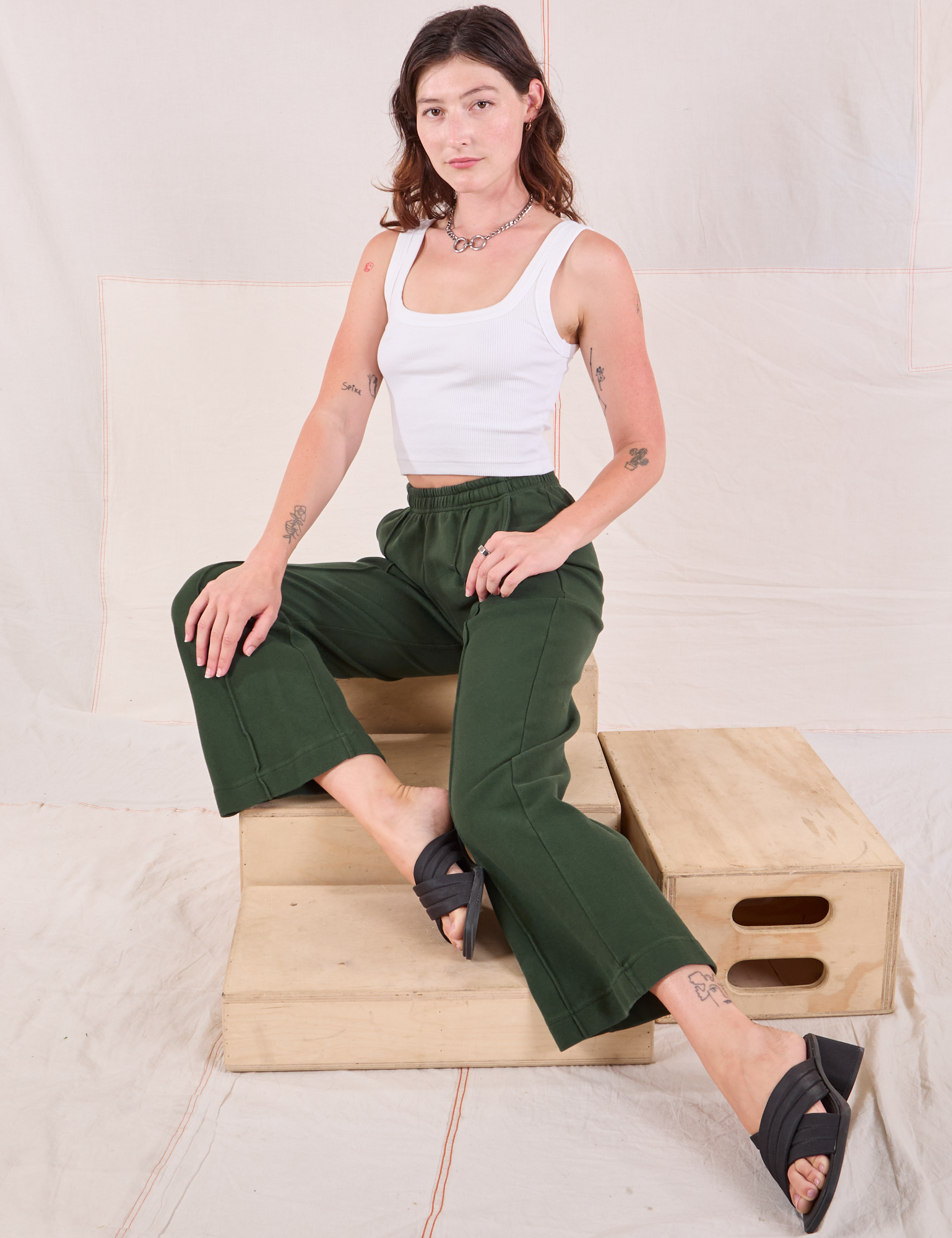 Alex is wearing Easy Western Pants in Swamp Green