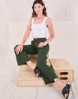 Alex is wearing Easy Western Pants in Swamp Green