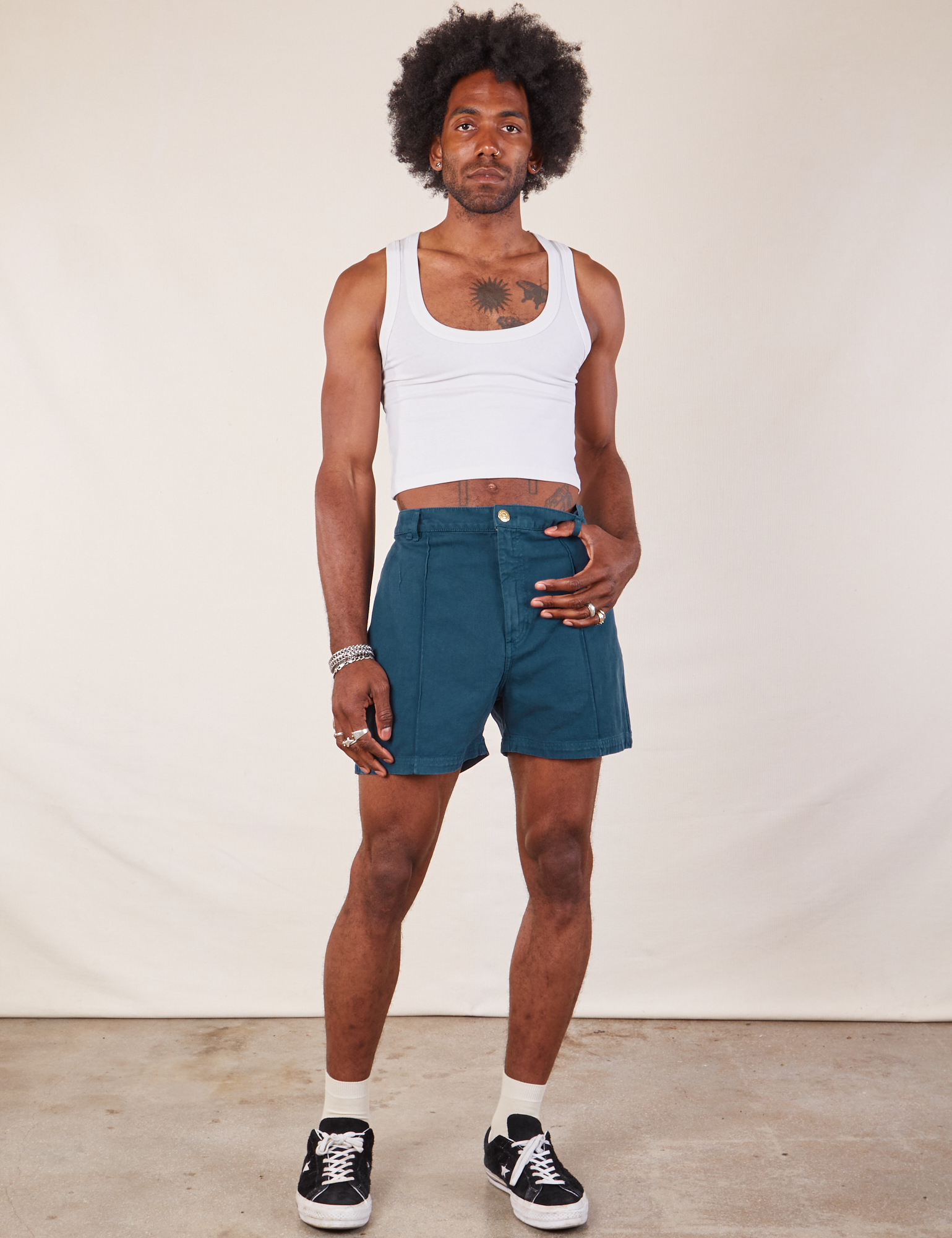 Jerrod is 6&#39;3&quot; and wearing M Western Shorts in Lagoon paired with Cropped Tank in vintage tee off-white