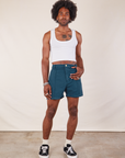 Jerrod is 6'3" and wearing M Western Shorts in Lagoon paired with Cropped Tank in vintage tee off-white