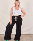 Lish is 5'8" and wearing M Wide Leg Sweat Pants in Basic Black paired with a Cropped Tank in vintage tee off-white