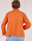 Denim Work Jacket in Construction Orange back view on Quinn