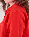 Denim Work Jacket in Mustang Red side shoulder close up on Alex