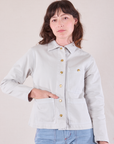 Alex is wearing a buttoned up Denim Work Jacket in Stone White