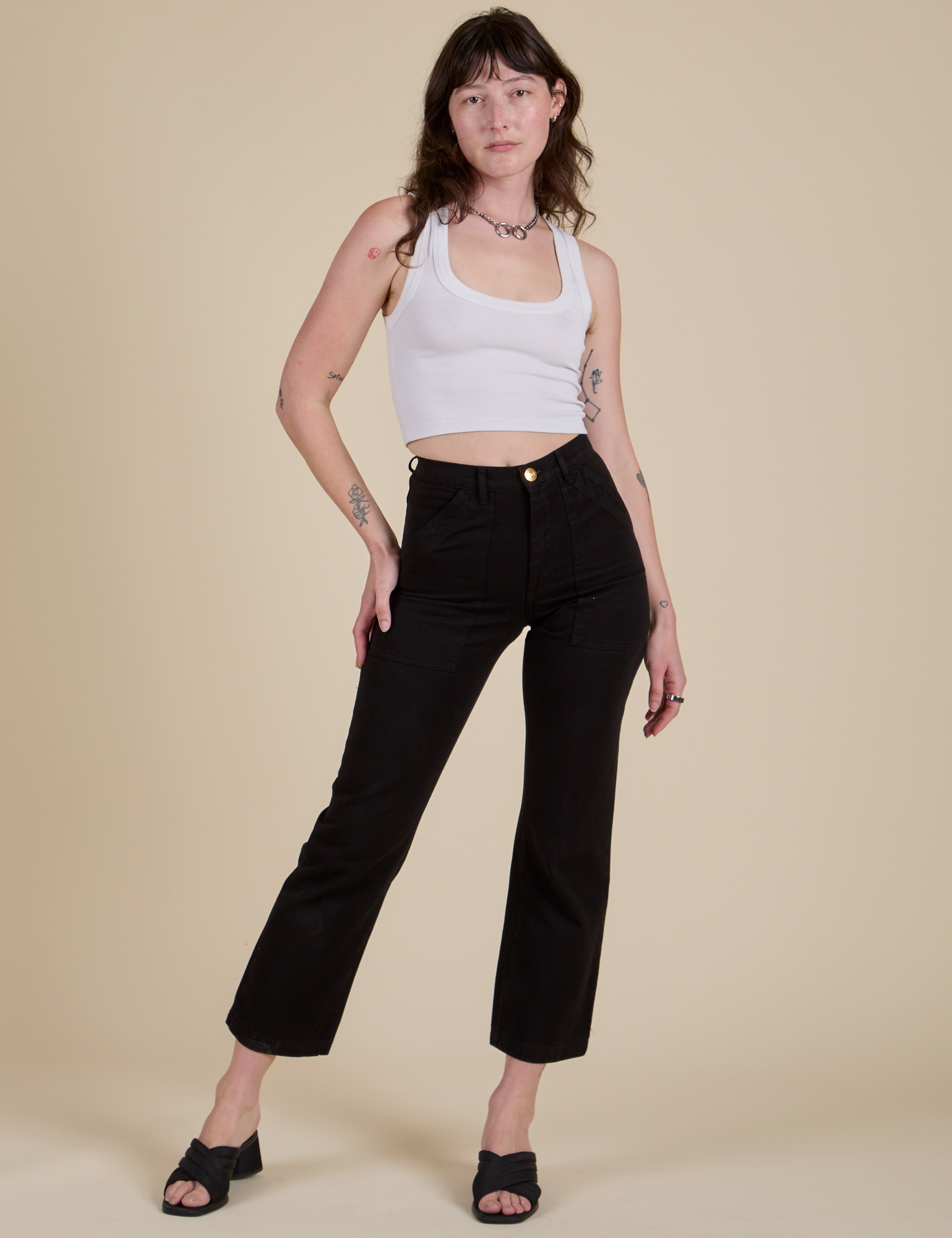 Alex is 5’8” and wearing XS Work Pants in Basic Black paired with a Cropped Tank in Vintage Tee White