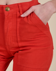 Close up of Alex's hand in the pocket of Work Pants in Mustang Red