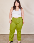 Ashley is 5'7" and wearing 1XL Work Pants in Gross Green paired with a Cropped Tank in vintage tee off-white