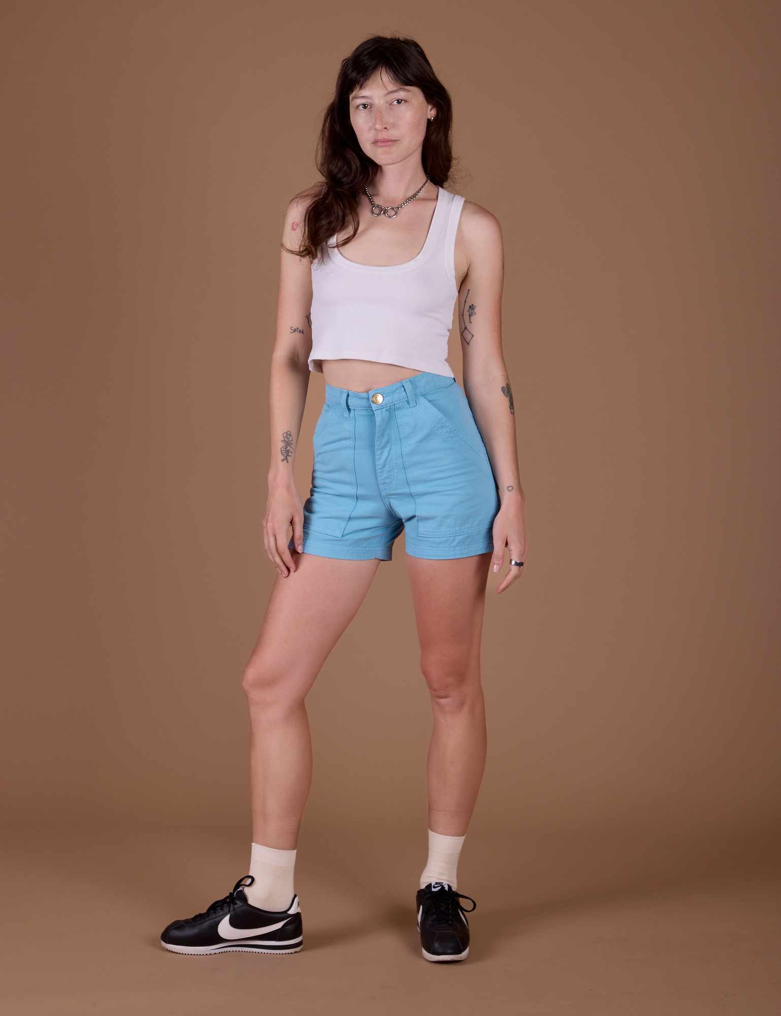 Alex is 5’8” and wearing XXS Classic Work Shorts in Baby Blue paired with vintage off white Cropped Tank