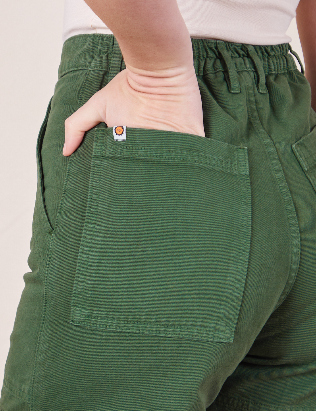 Classic Work Shorts in Dark Emerald Green back pocket close up on Alex