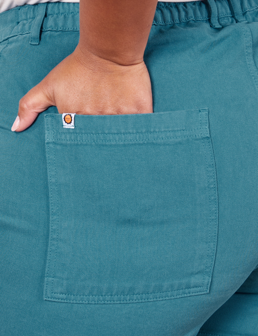 Back pocket close up of Classic Work Shorts in Marine Blue. Morgan has her hand in the pocket.
