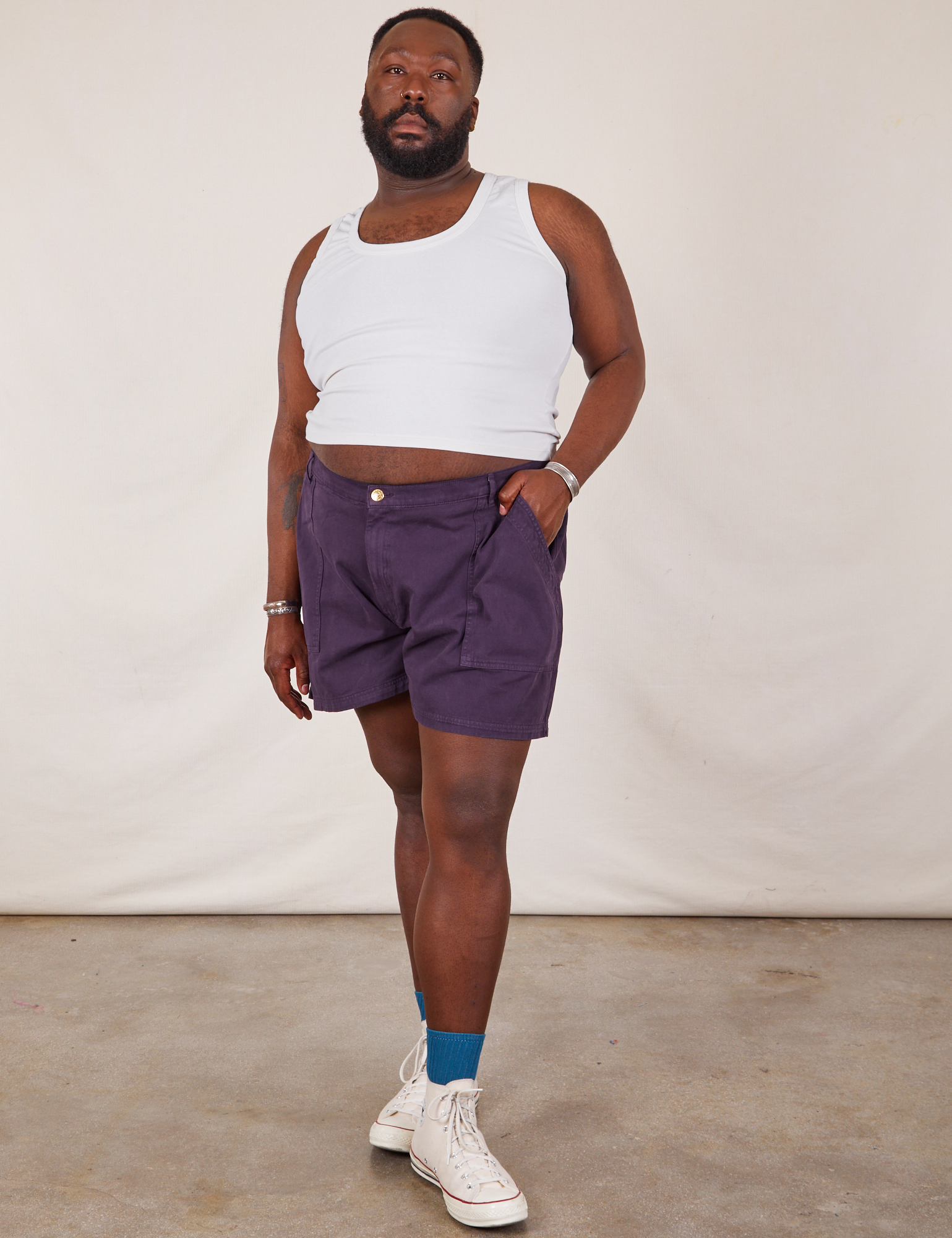 Elijah is 6’0” and wearing 3XL Classic Work Shorts in Nebula Purple paired with Tank Top in vintage tee off-white