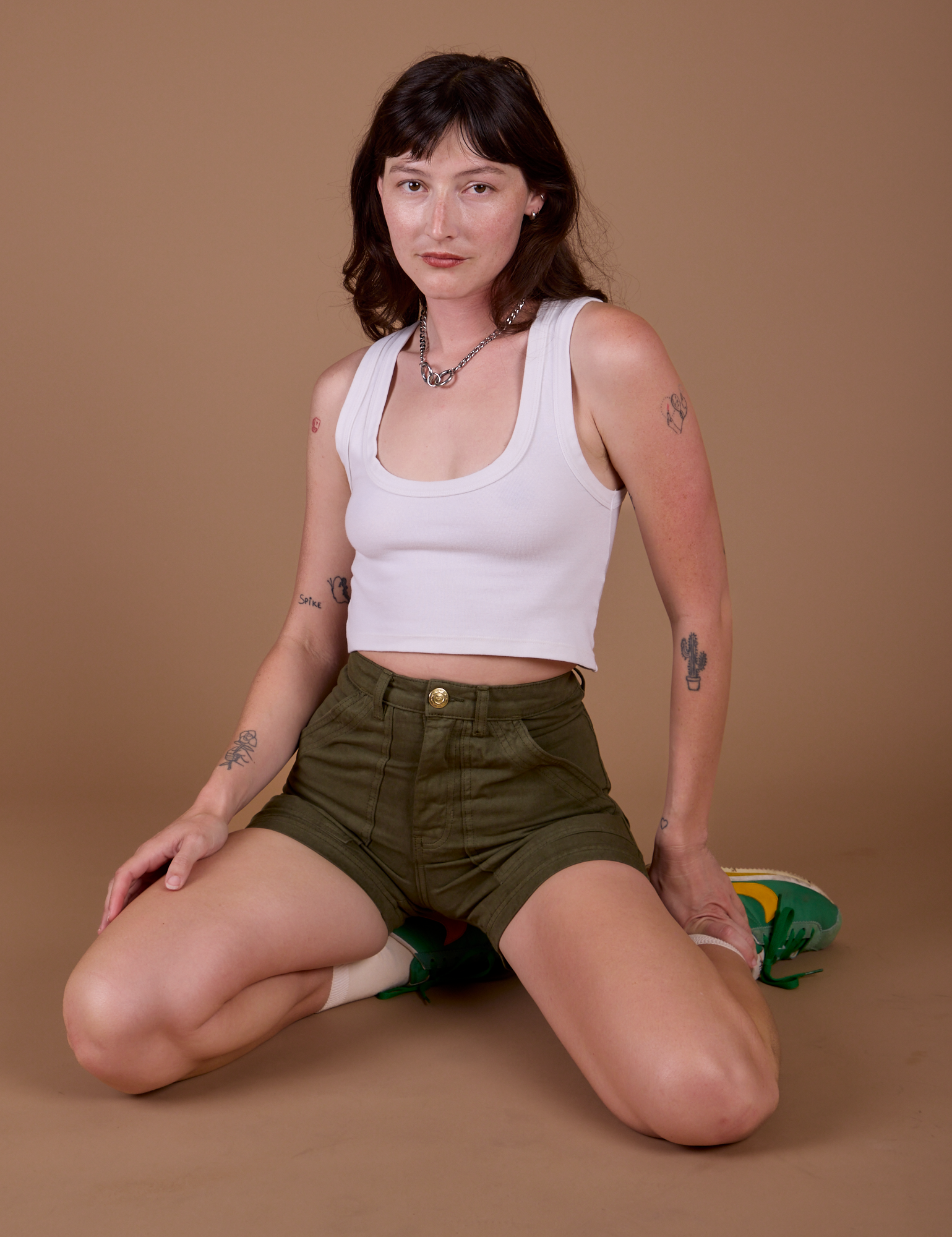 Alex is wearing Classic Work Shorts in Surplus Green and vintage off white Cropped Tank