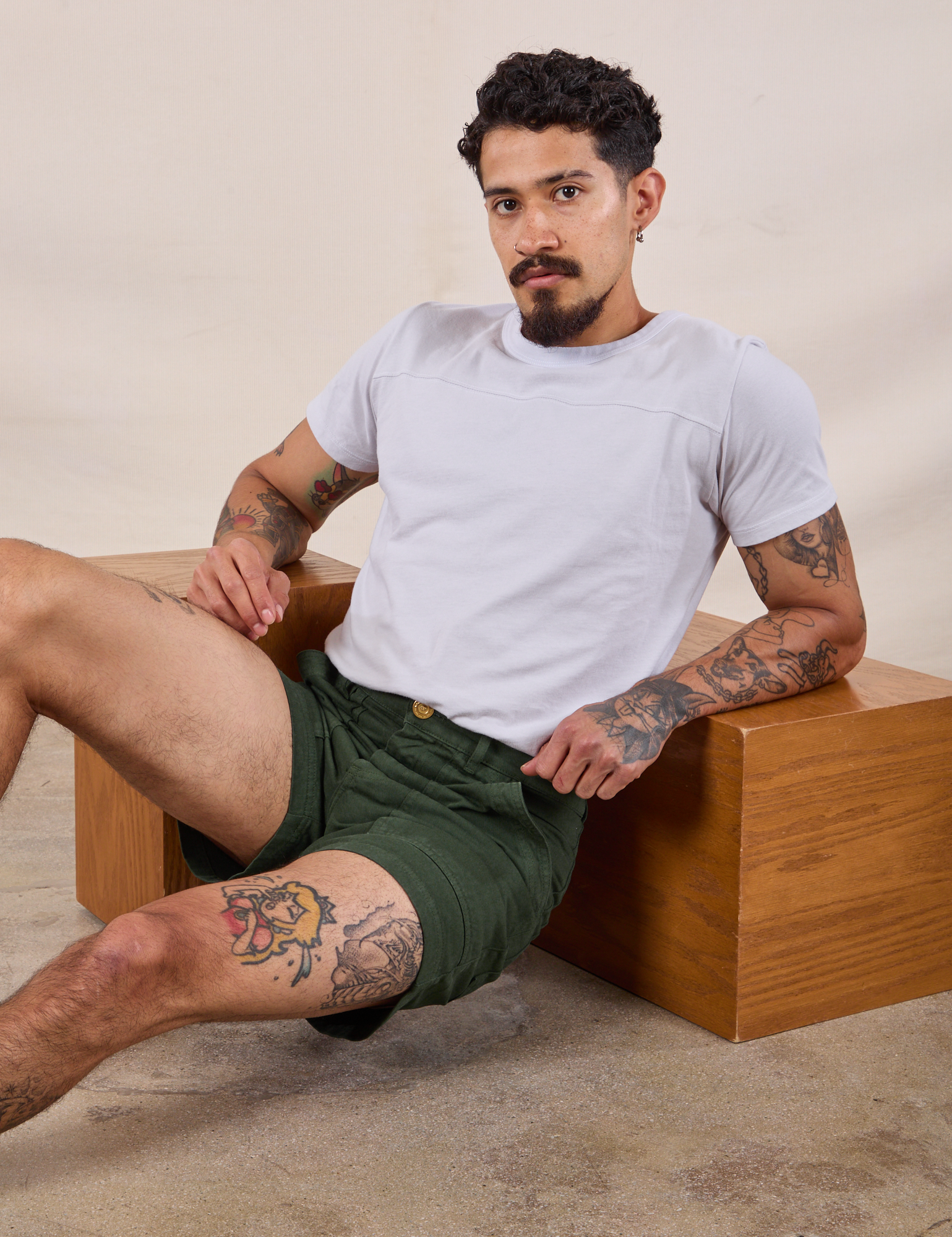 Jesse is wearing Classic Work Shorts in Swamp Green and Jr. Varsity Tee in Stone White 