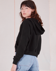 Cropped Zip Hoodie in Basic Black angled back view on Alex