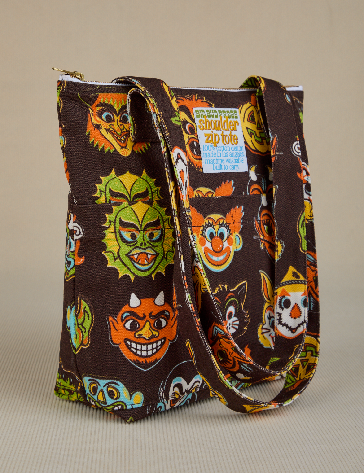 Angled front view of Halloween Masks Shoulder Zip Tote