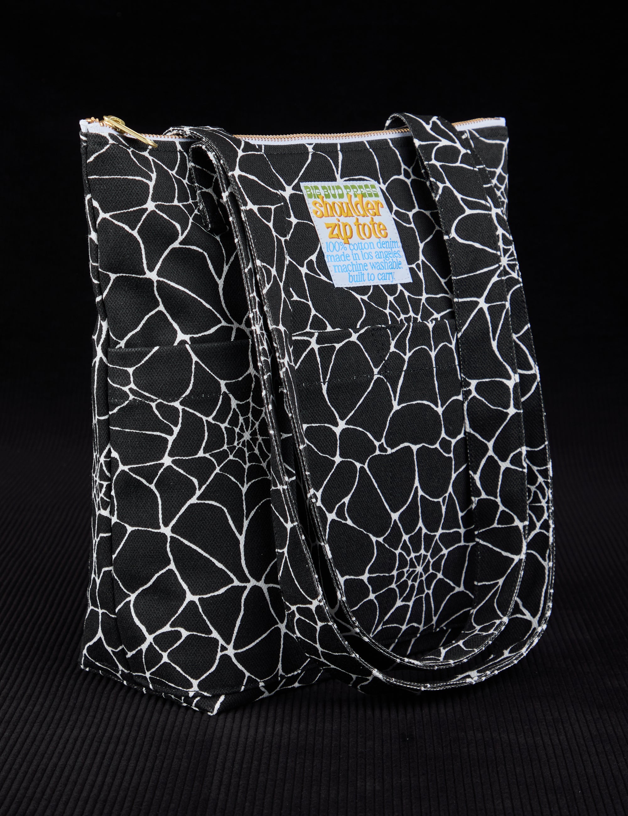 Angled view of Spider Webs Printed Shoulder Zip Tote