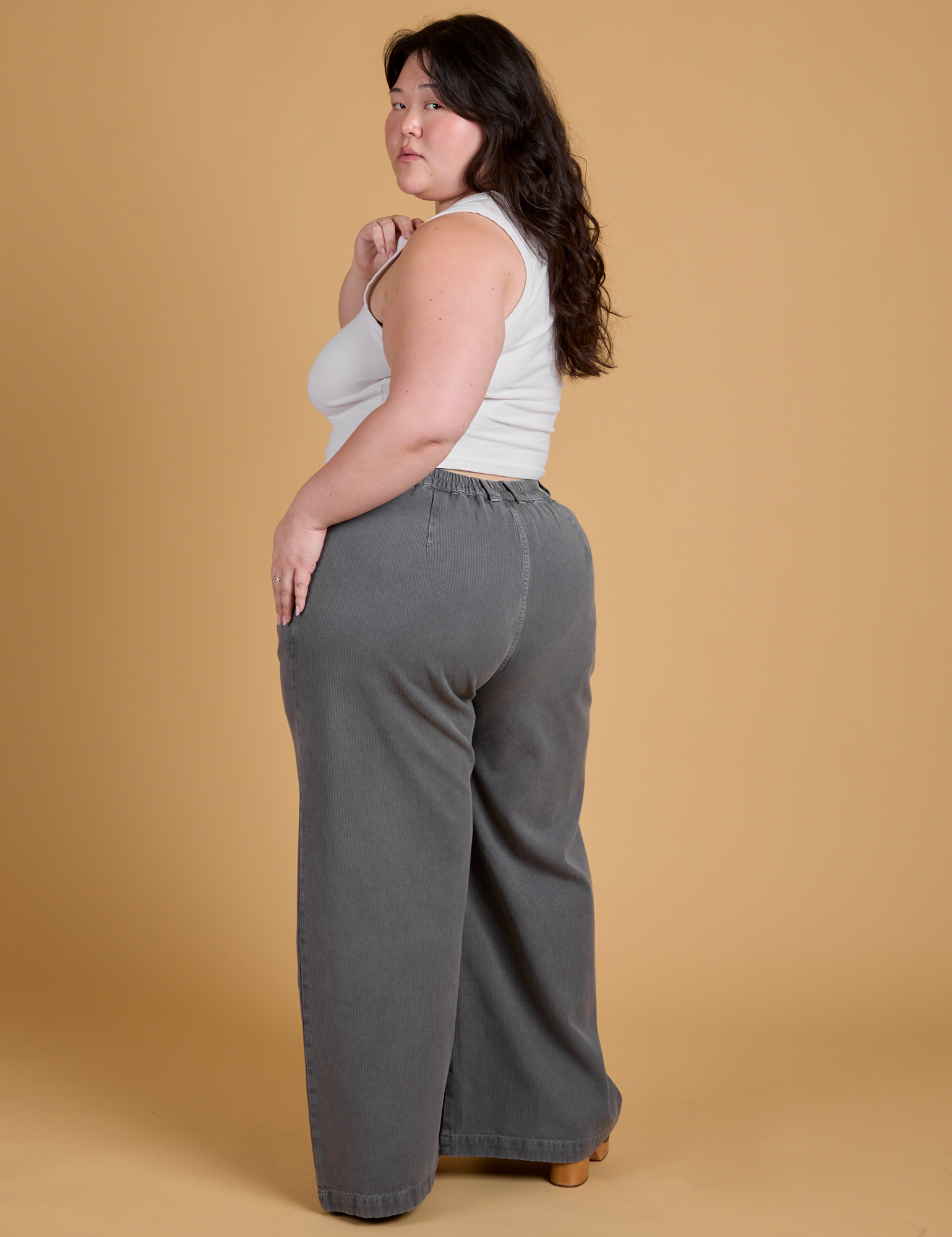 Angled back view of Heritage Wide Leg Trousers in Washed Grey on Ashley